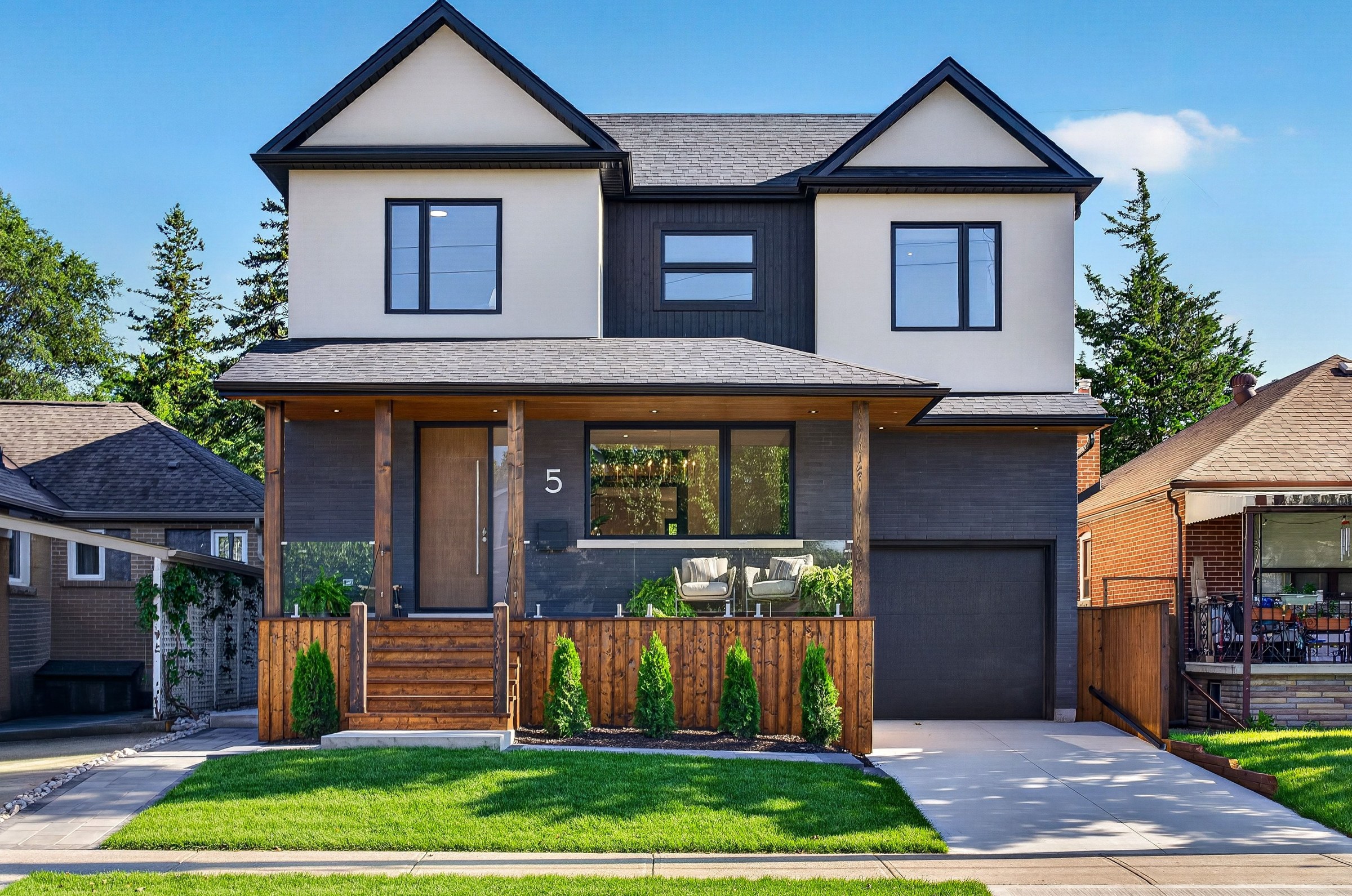 Daylight exterior of 5 North Drive with a wood porch and dark architectural framing