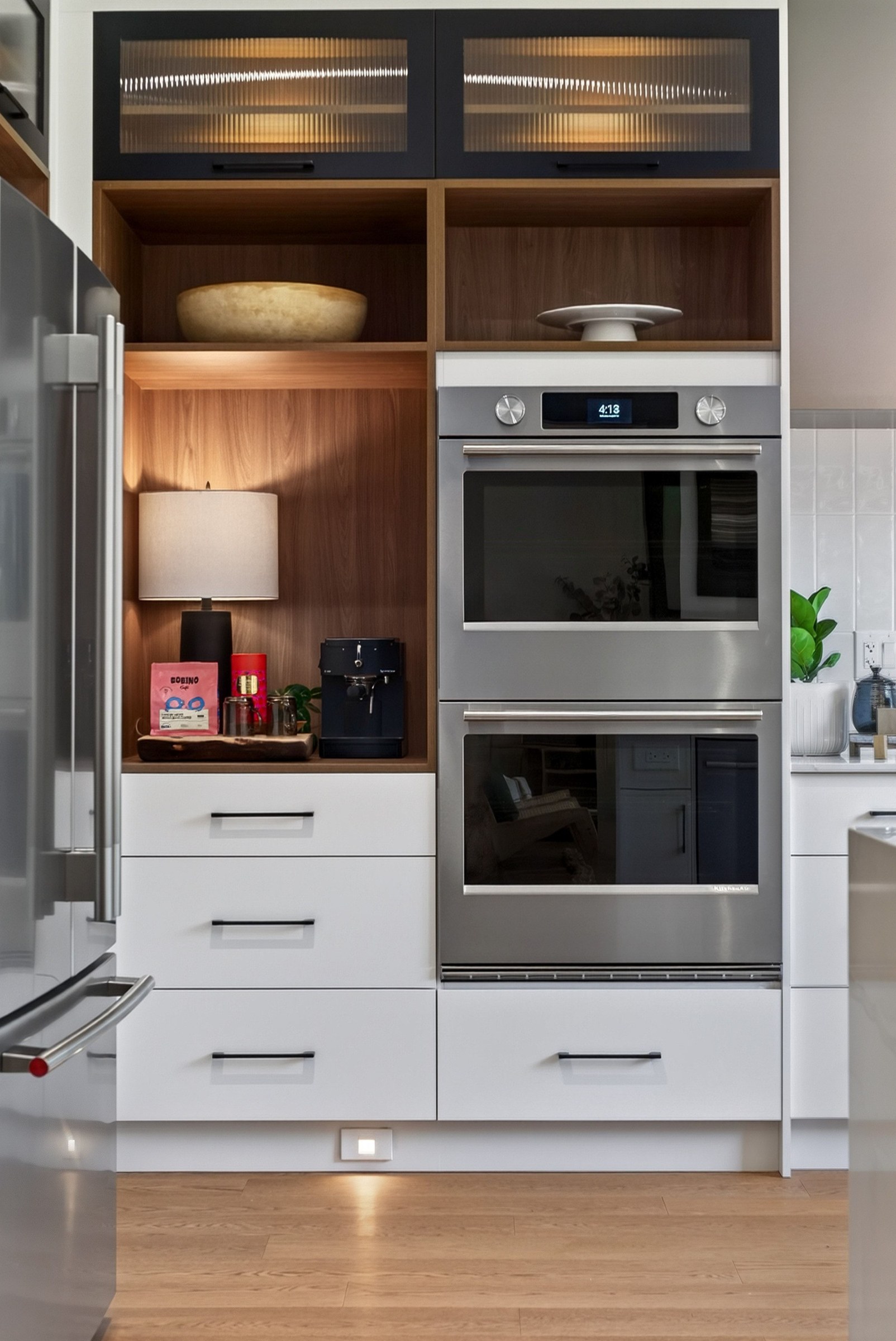Wood shelves, ribbed glass cabinetry and a coffee corner