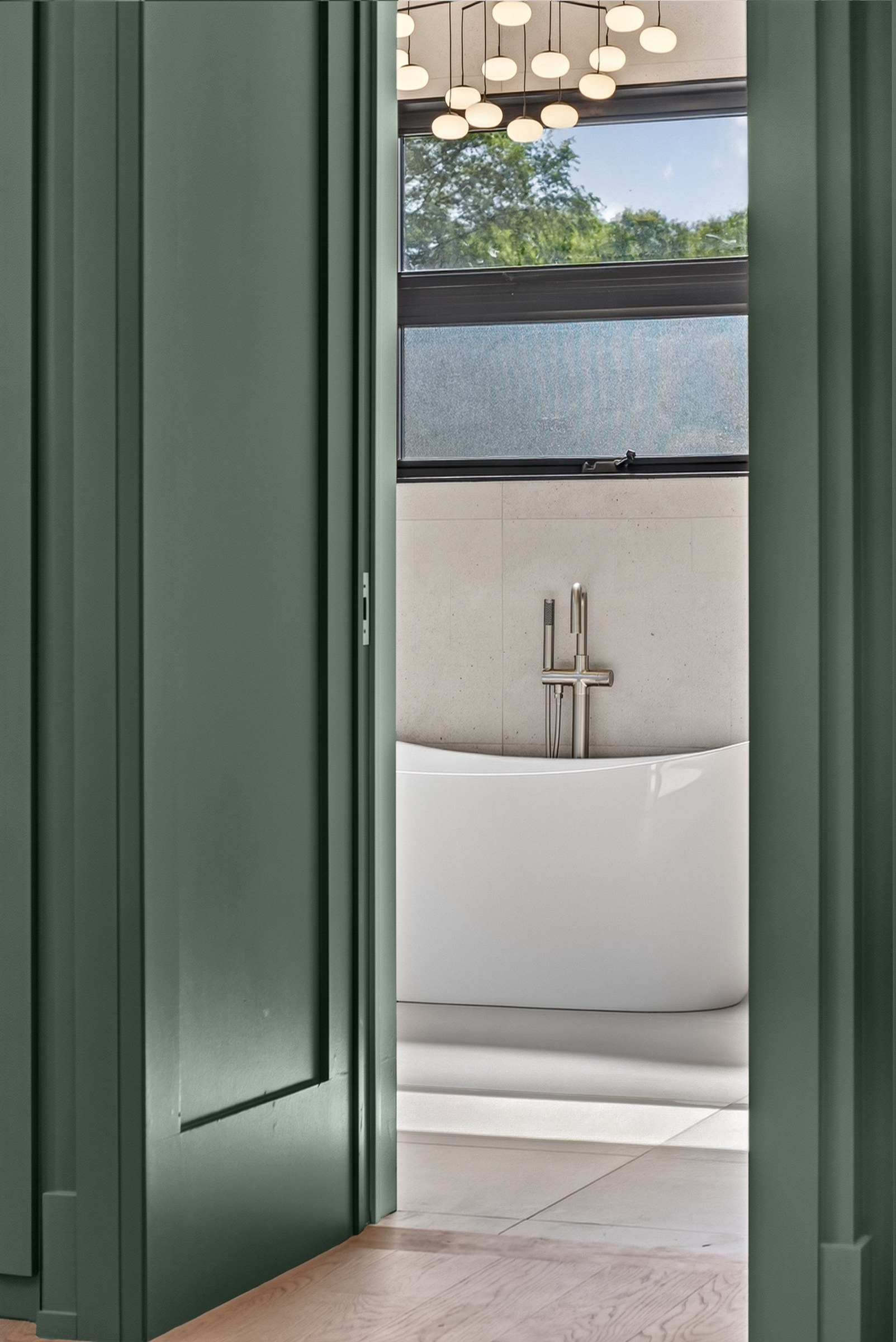 A glimpse of the bath through the green doorway