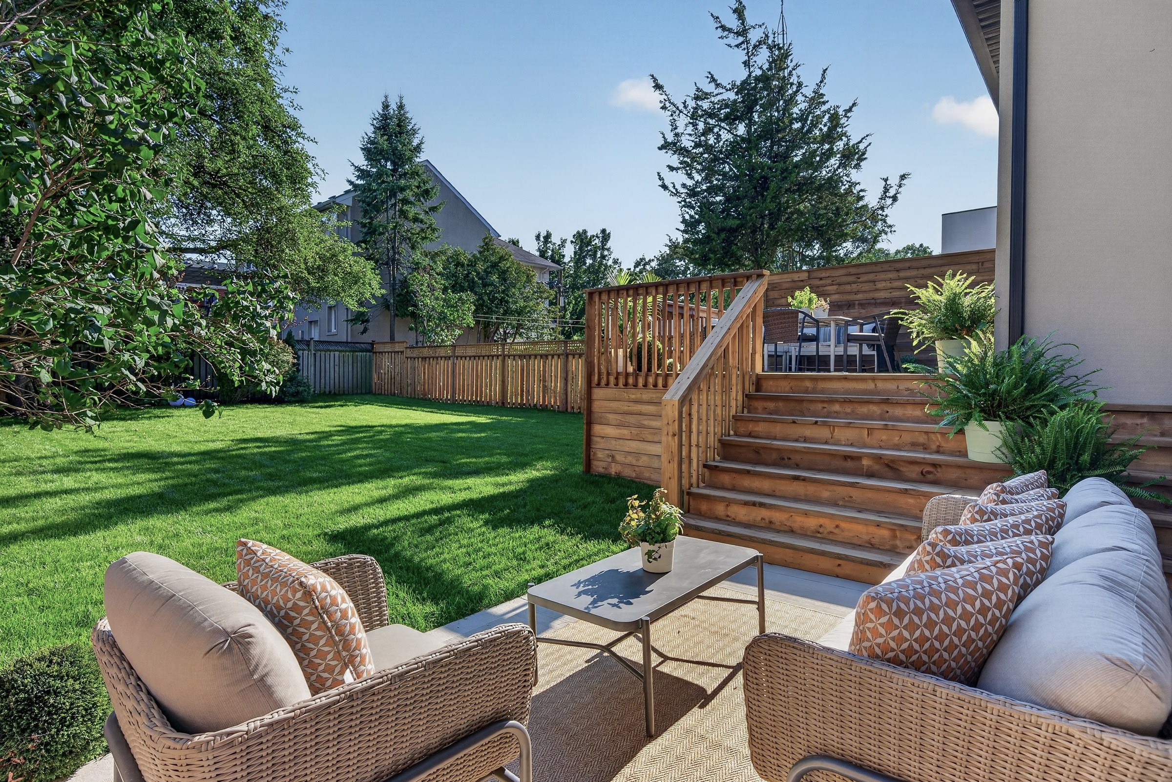 Daylight across the garden, deck steps and outdoor seating